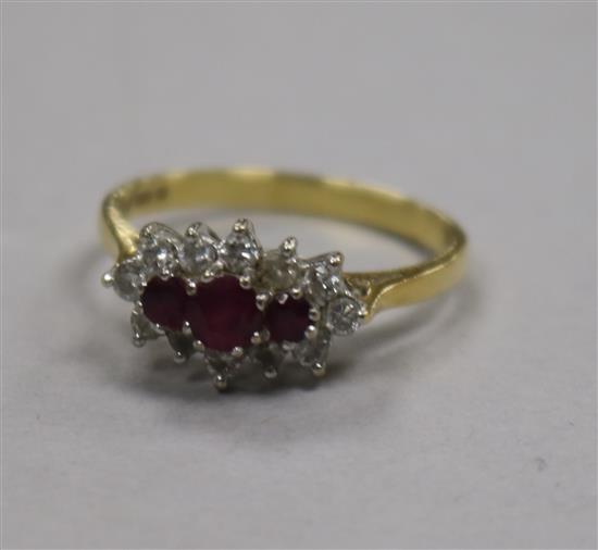 A 1980s 18ct gold ruby and diamond cluster ring, size P.